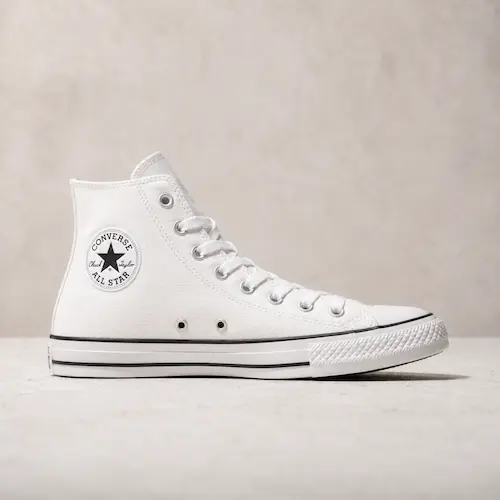 Converse Chuck Taylor style white high top sneakers shown as classic canvas shoes for men’s casual outfits