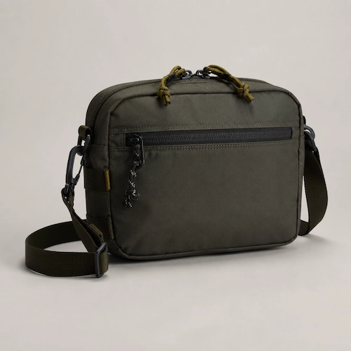 Topo Designs-style navy mini quick pack with orange detail shown as a compact sling bag for men